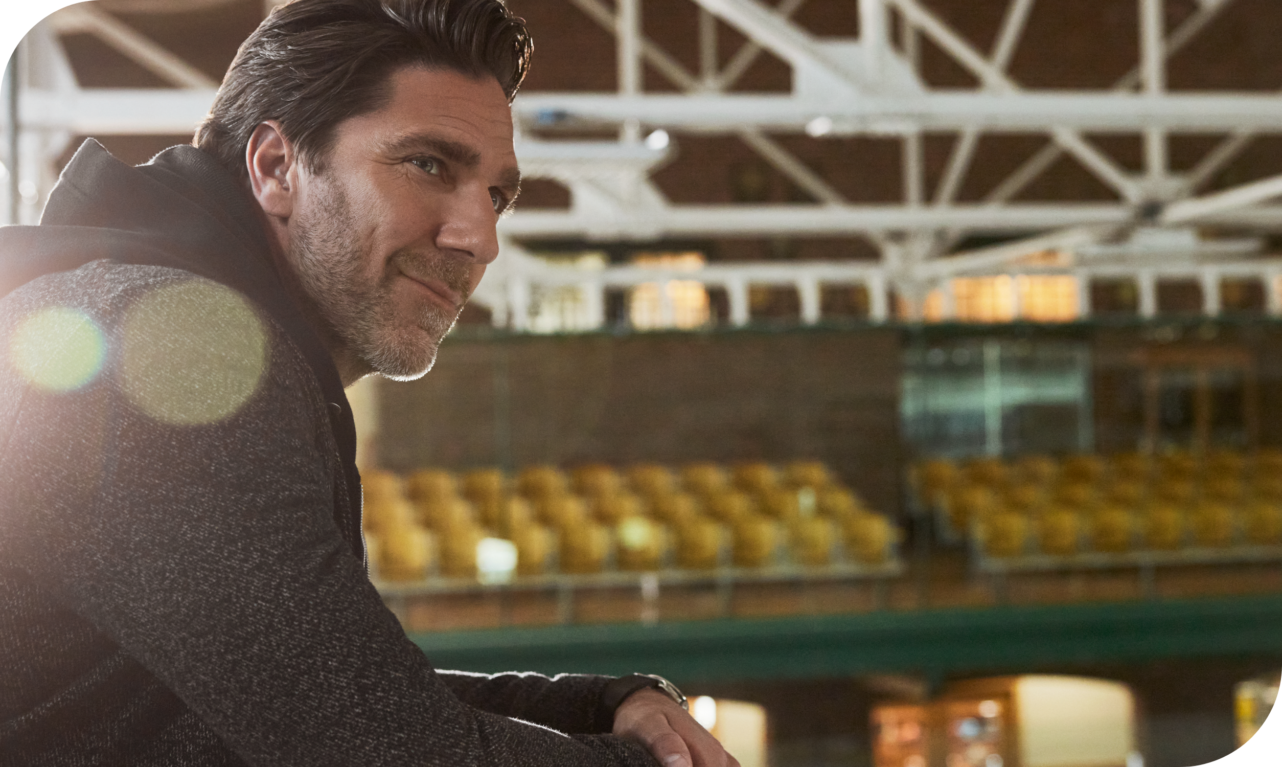 Henrik Lundqvist looking out at a hockey rink and smiling