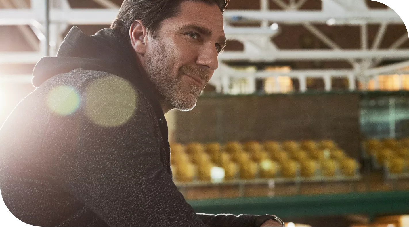 Henrik Lundqvist looking out at a hockey rink and smiling